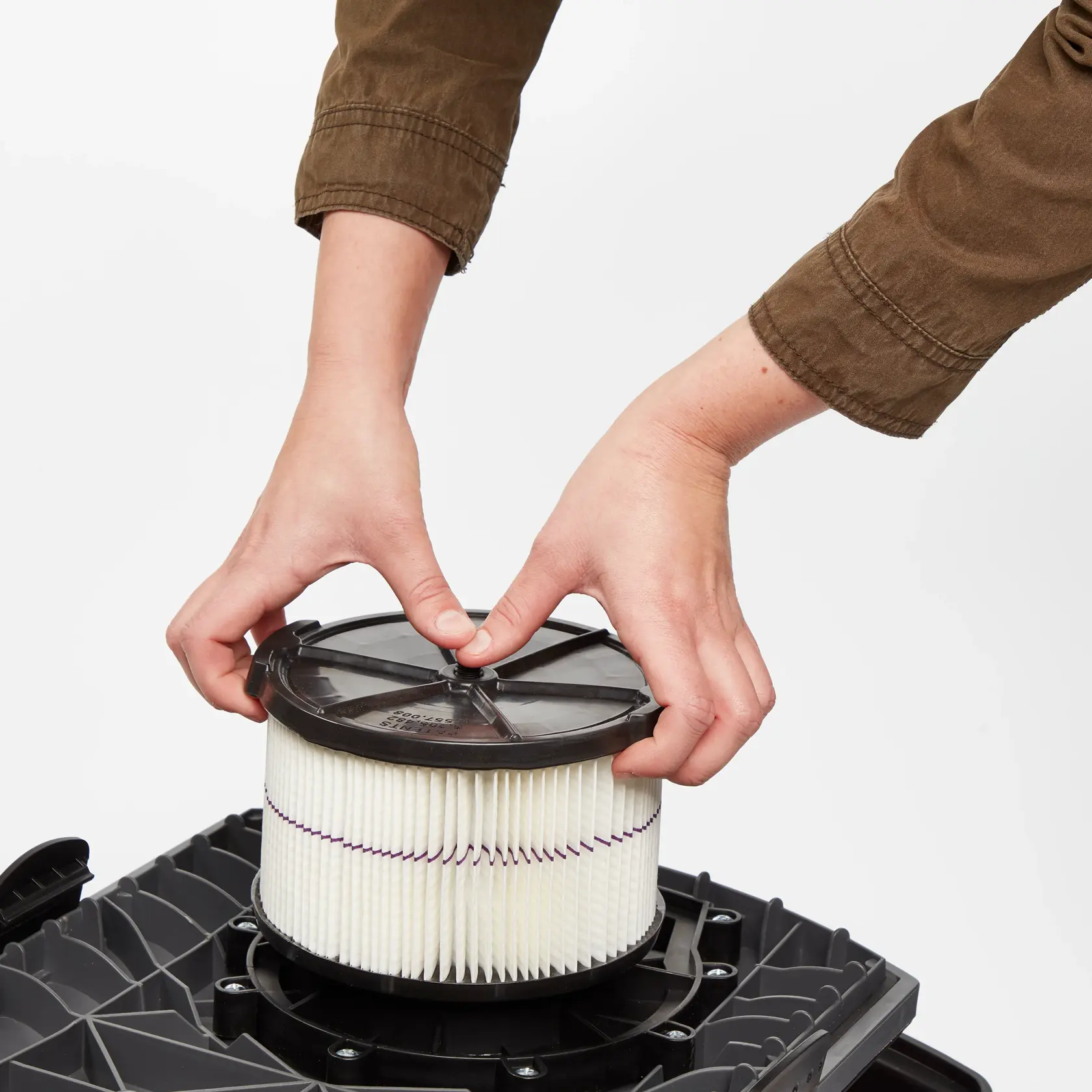 Person installing CRAFTSMAN 1/2 Height General Purpose Wet/Dry Vac Filter on a vac