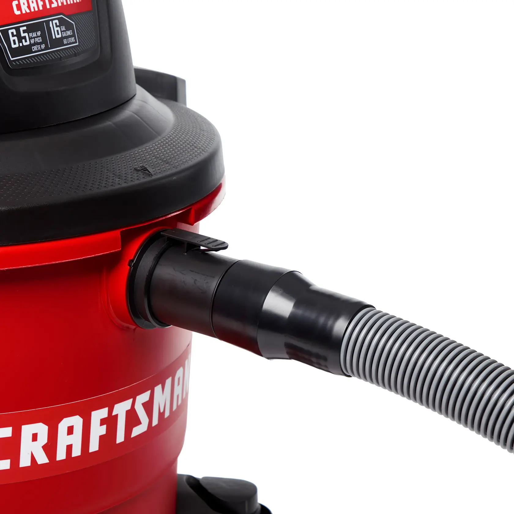 Side view of premium hose attachment locked onto inlet of wet/dry shop vacuum drum