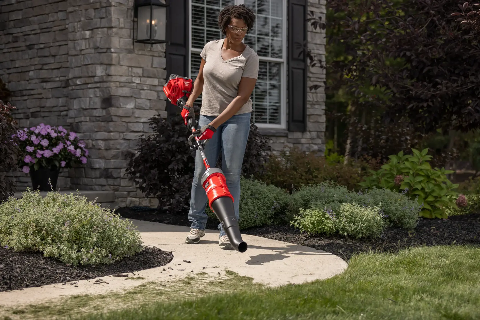 CRAFTSMAN Multi-Tool Attachment Blower blowing sidewalk off in front of house