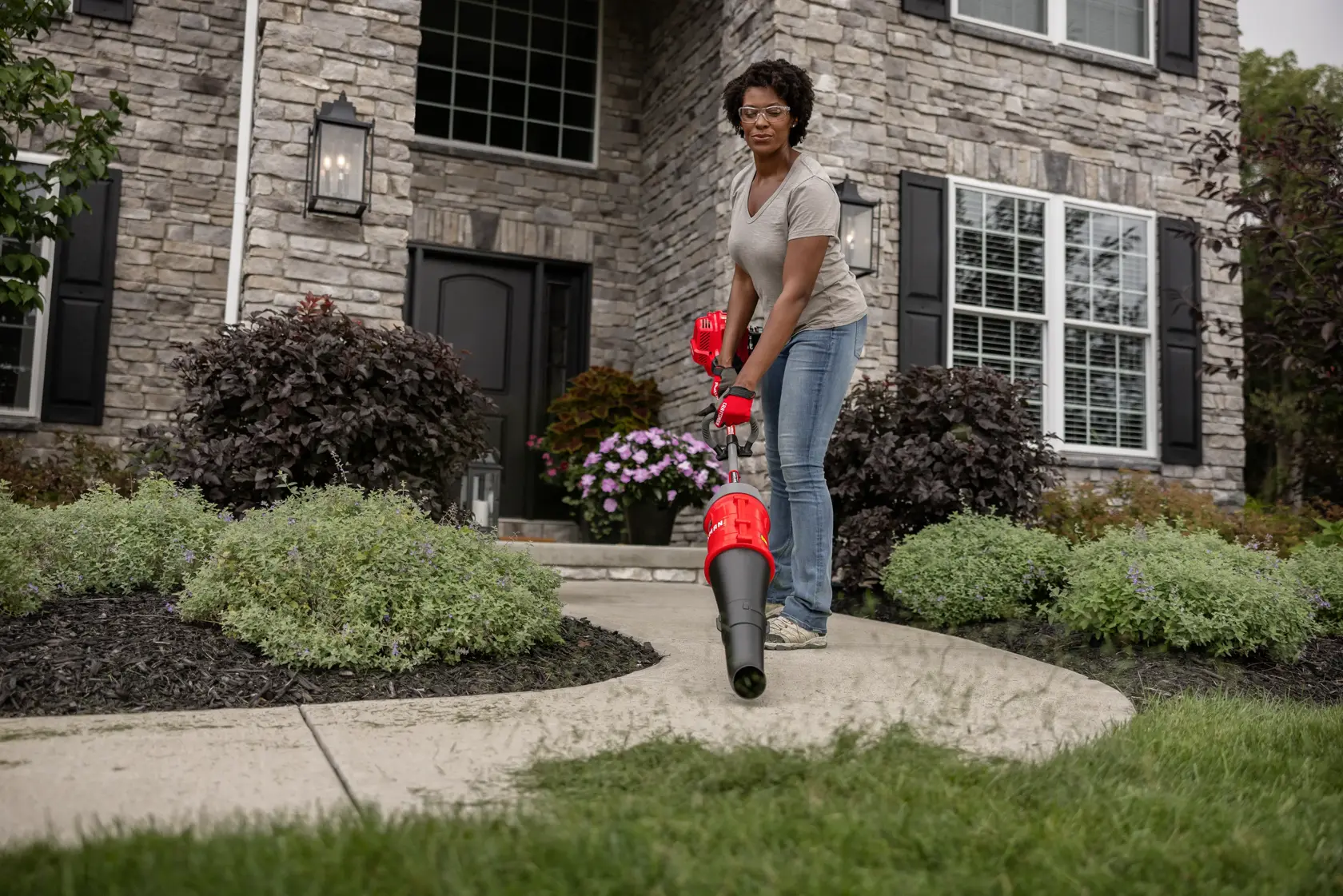 CRAFTSMAN Multi-Tool Attachment Blower blowing sidewalk off in front of house